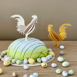 Lovi ROOSTER (3.9"/ 10 cm) in natural and yellow color decorating an Easter cake