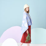 Kauniste TALVIYÖ Merino Wool Throw Small in blue color on shoulders of a model
