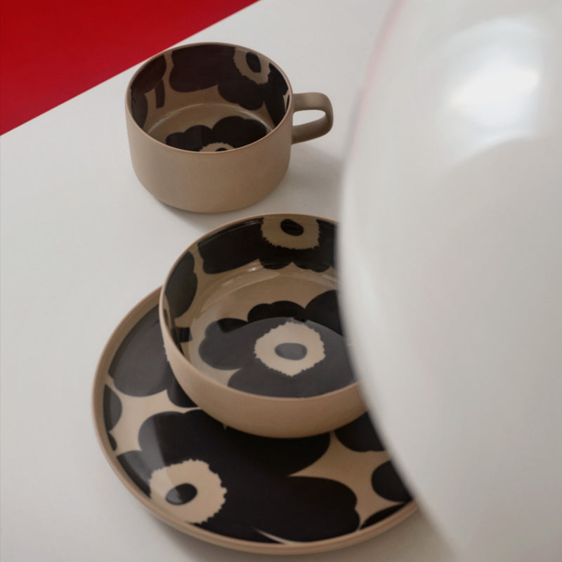 Marimekko UNIKKO teacup, bowl and plate on the table brown stoneware