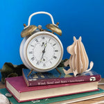 Lovi Moomintroll with a clock on the table